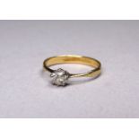 A solitaire diamond set in a yellow metal band - size P, weight 2.1g.