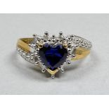 A 9ct gold sapphire and diamond ring - with a heart shaped stone and crossover setting, size N,