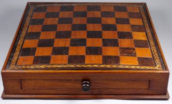 A mid 19th century draughts board - with a walnut carcass and rosewood/satinwood squares within