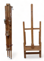 A beech artist's easel - of tripod form, together with another easel. (2)