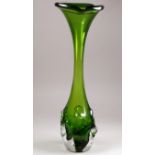 A mid 20th century green art glass vase - possibly Italian, of trumpet form with a dimpled bulb,