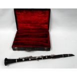 An early 20th century ebony clarinet by Boosey & Hawkes - with nickel fittings, in a case for two