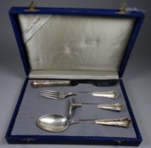 A 20th century German white metal christening set - comprising four items, the handle engraved '