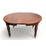 A late Victorian mahogany circular extending dining table - with two leaf insertions, the moulded