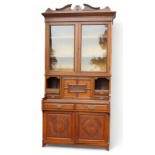 A Victorian walnut secretaire bookcase - the carved cornice above a pair of glazed panel doors