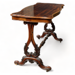 A Victorian mahogany and rosewood side table - the shaped rectangular top on lyre shaped supports