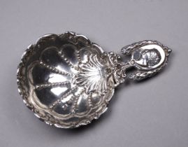 A large elaborately decorated caddy spoon - import marks for London 1892, length 10.6cm, weight 32g.