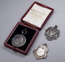 Three silver sporting fob medals - one cased.