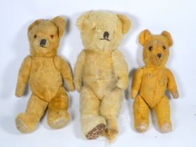 An early 20th century golden plush teddy bear - amber eyes and articulated limbs with faun pads,