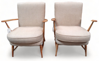 A pair of beech framed Ercol easy chairs, Model 203 - covered in original fawn fabric, with open