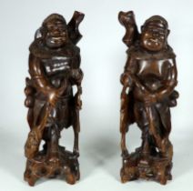 A pair of early 20th century Chinese carved hardwood figures - in the form of immortals, 32cm