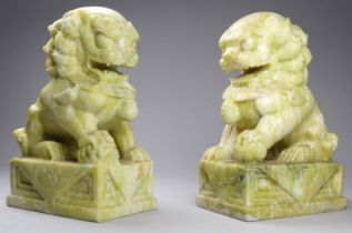 A pair of Chinese soapstone Dogs of Fo - each seated on a rectangular plinth, 13cm high (2)