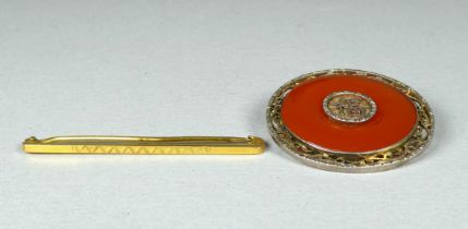 An amber jade brooch - annular with white metal mounts incorporating Chinese characters, together