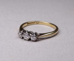 A 9ct three stone diamond ring - size L, 2g