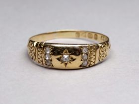 An 18ct gold and diamond set ring - gypsy setting in a foliate band size T, 2.7g