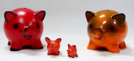 A Goebel pottery piggy bank - orange glazed, 18cm wide, together with another similar red glazed