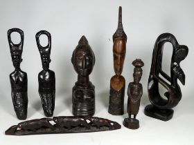 An African hardwood carving of a Nigerian female - Yoruba tribe, height 26cm, together with six