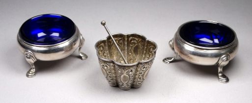 A pair of Georgian silver cauldron type salts - indistinct marks, raised on three pad feet with blue