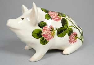 Wemyss Griselda Hill pottery pig - seated, decorated by Ester Weeks with clover flowers, 18cm wide