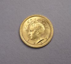 A one Pahlavi 22ct gold coin - obverse with bust of Mohammed Reza, the reverse with a lion holding a