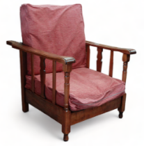 An early 20th century oak converting reclining bed chair - with plum feather upholstered cushions.