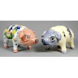 A Quimper pottery piggy bank - decorated with flowers, 21cm wide, together with another Quimper