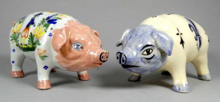 A Quimper pottery piggy bank - decorated with flowers, 21cm wide, together with another Quimper