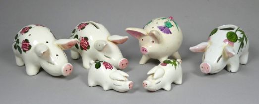 A Plichta pottery pig in the manner of Wemyss - decorated with clover flowers, 11cm long, together