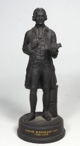 A Wedgwood basalt figure of Josiah Wedgwood - standing holding a pot and raised on a socle base,