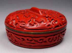 An early 20th century Chinese cinnabar lacquer pot and cover - decorated with leaping amongst