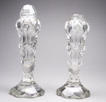 A pair of early 20th century cut glass cruet - of facetted baluster form (one lacking cover), 16cm