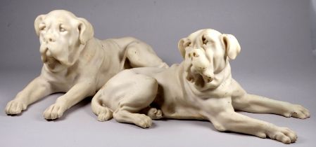 A pair of cast stone dogs - in the manner of alabaster, modelled as recumbent German mastiffs, width