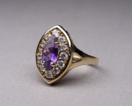 A 9ct gold amethyst and white stone set dress ring - with navette shaped central stone, size N, 3.