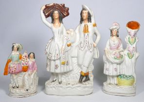 A 19th century Staffordshire flatback spill holder - modelled as a woman with grapevine and basket