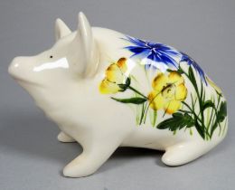 Wemyss Griselda Hill pottery pig - seated, decorated with blue and yellow flowers, 18cm wide