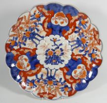 An early 20th century Japanese Imari charger - decorated in typical fashion with scalloped rim,