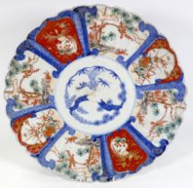 An early 20th century Japanese Imari charger - decorated in typical fashion with scalloped rim,