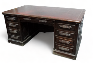 An early 20th century mahogany pedestal desk - the leather inset top with gilt tooling above an