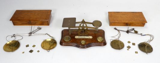 A set of brass postal scales - together with three weights, width 20cm, together with two further