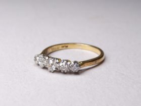 An 18ct five stone diamond ring - of graduated stones, size R 3.5g