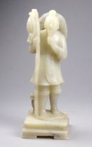 An early 20th century carved jade figure of a fisherman - standing stroking his beard and raised