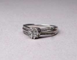 A 9ct white gold and diamond cluster ring - with diamond set shoulders, size K, 2.4g