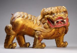 A Chinese gilt and polychrome painted lion - 20cm wide