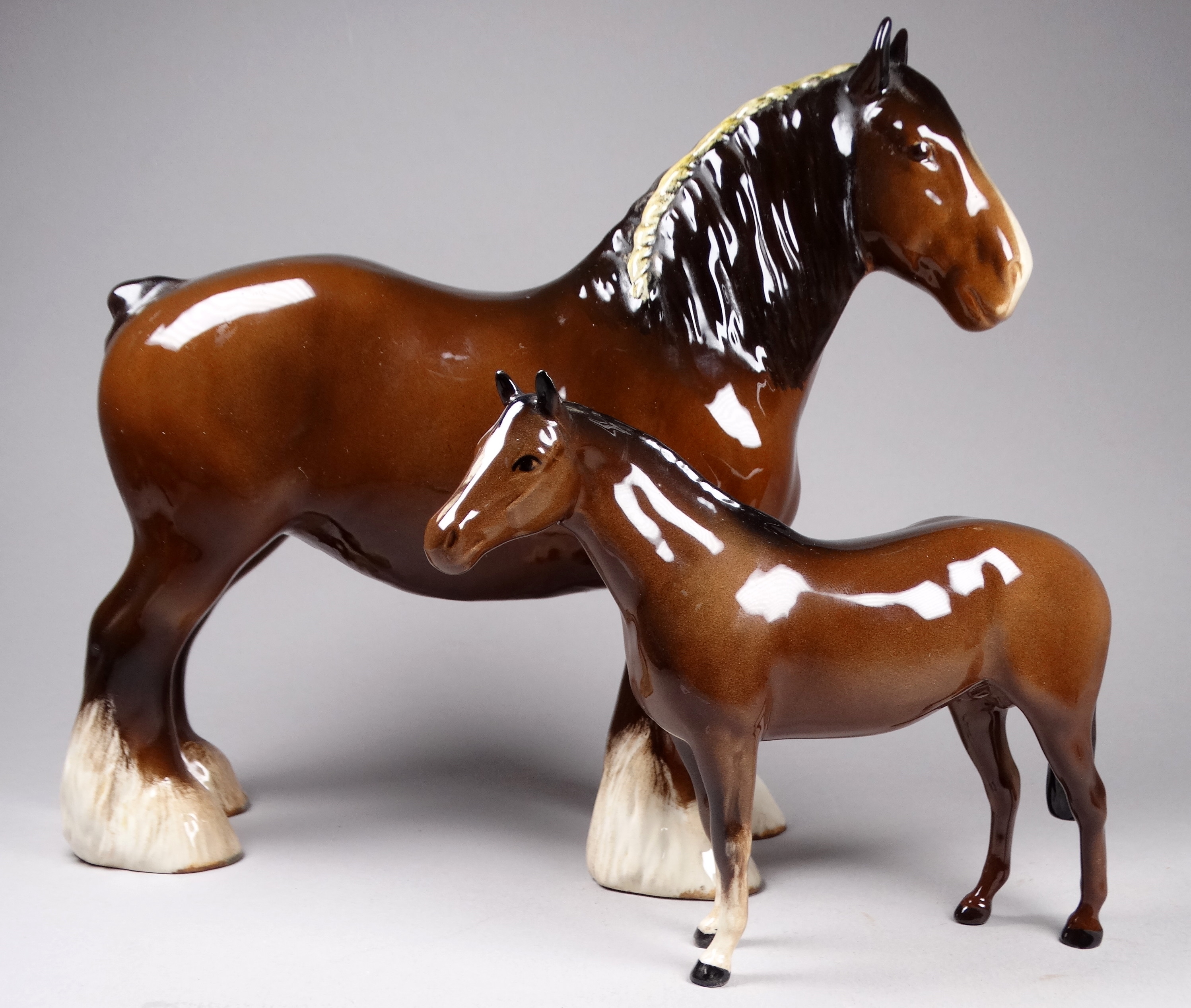 A Beswick bay shire horse - standing, 21cm high, together with a smaller bay stallion (2)