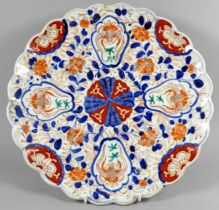 A late 19th Imari dish - circular with a scalloped edge, decorated in a traditional palette 31cm