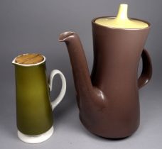 A Poole Pottery coffee jug - in a chocolate brown matte finish with a yellow cover, 22cm high,