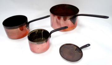 A harlequin set of three 19th century graduated copper saucepans - with iron handles and