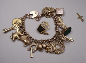 A 9ct gold charm bracelet - curb link with approximately twenty six various charms, weight 44.4g.