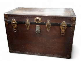 An impressive early 20th century travelling trunk - with leather handles and brassed fittings, the