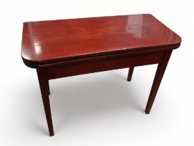 A 19th century mahogany tea table - the rectangular fold over top above tapering square legs 102cm x